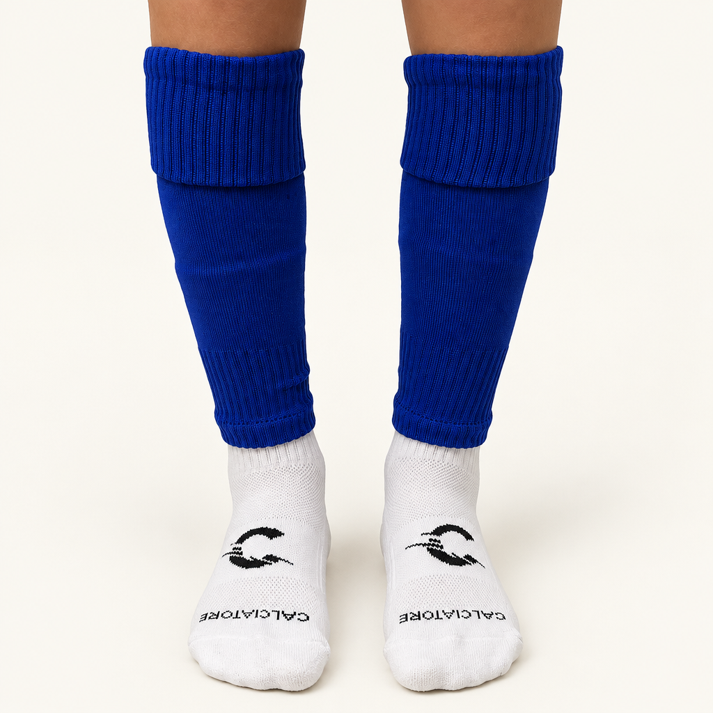 Blue football sock sleeves worn with white socks on a neutral background