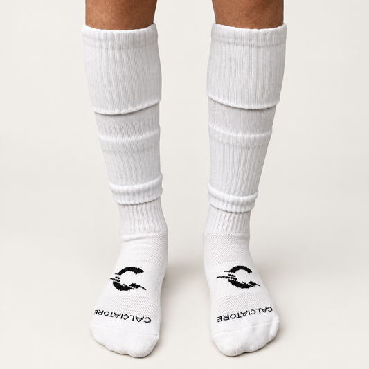 White football sock sleeves worn with white socks on a neutral background